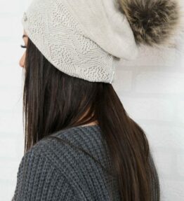 Beige hat with a pompon